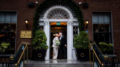 a bride & groom kiss on the steps of the Iveagh Garden Hotel